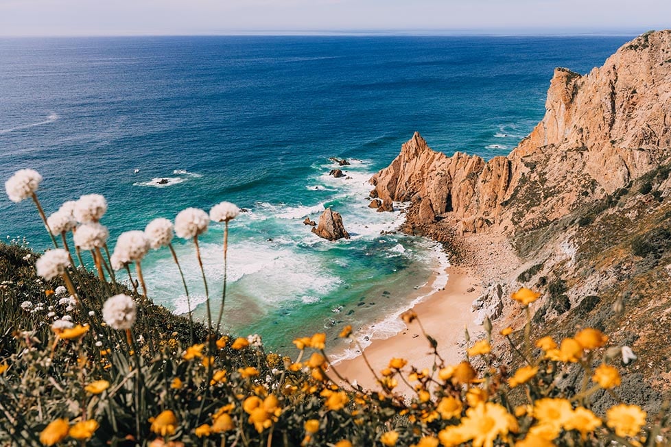 Rocky cliff and a beach off the coast of Portugal