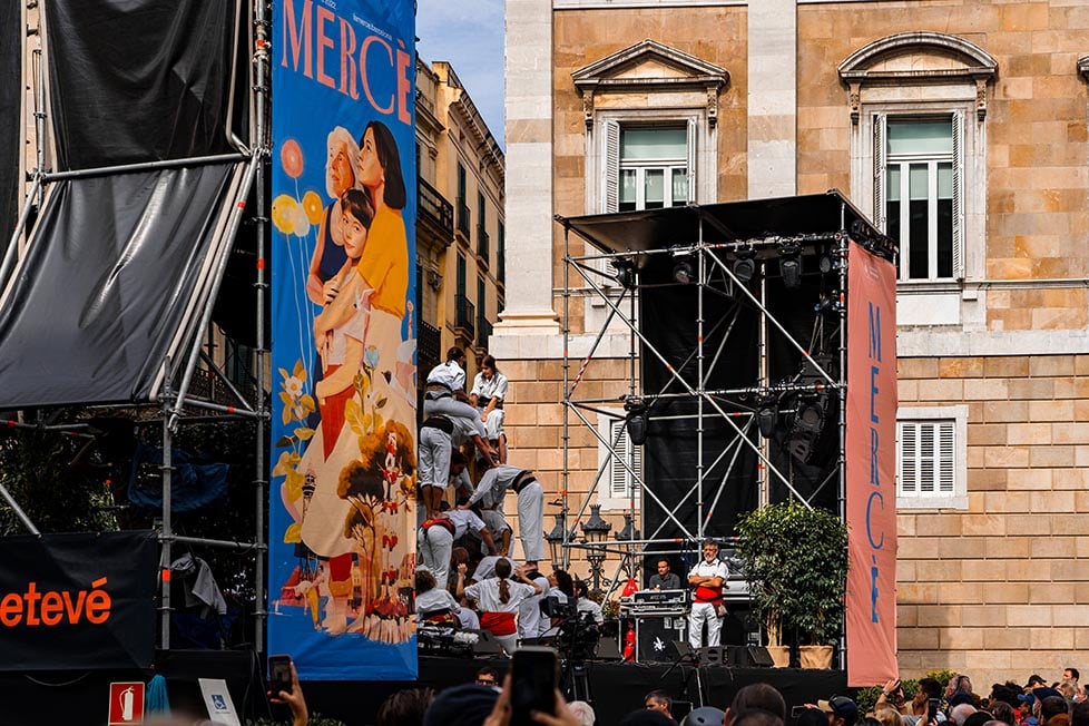 People climbing on top of each other to form a structure at a festival in Spain