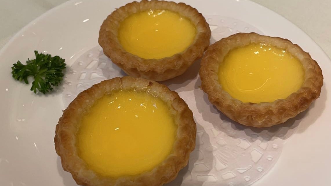 circular shaped pastries with bright yellow egg custard in the middle