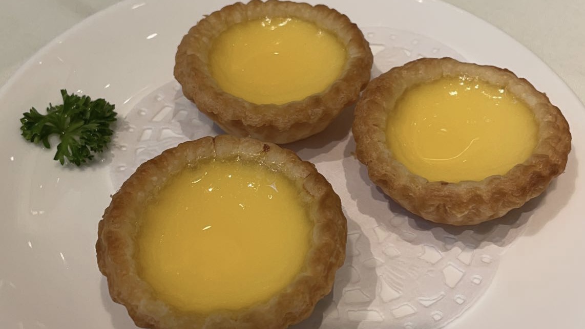 circular shaped pastries with bright yellow egg custard in the middle