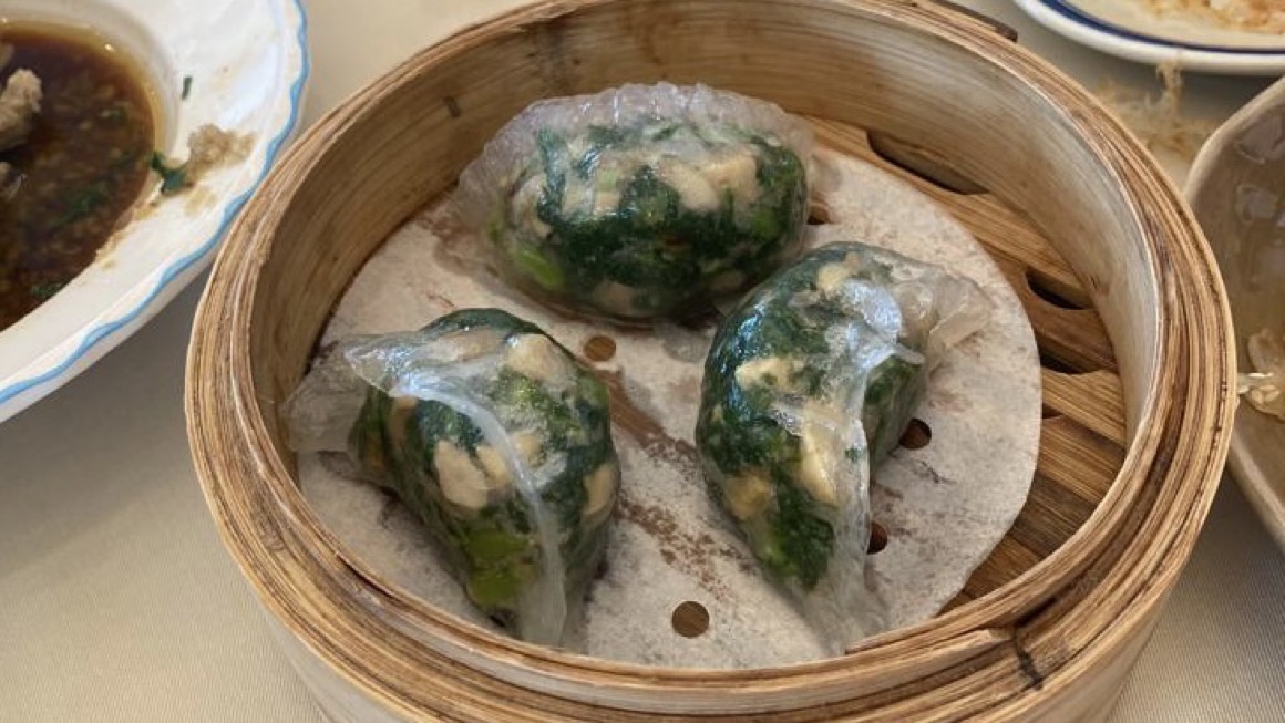 three translucent dumplings filled with spinach and tofu in hong kong