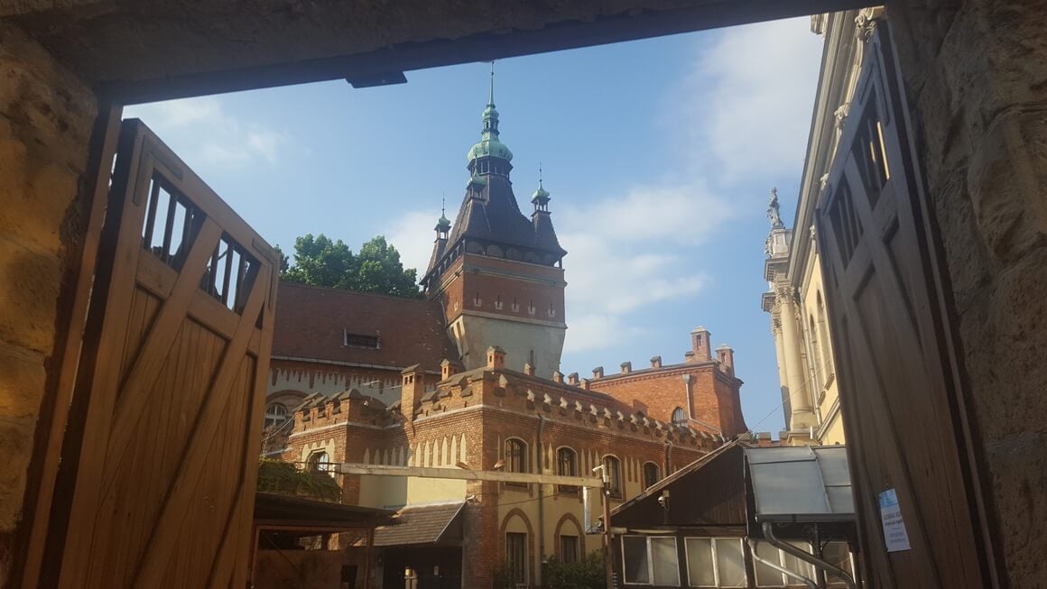 Hungarian style tower behind a wooden gate