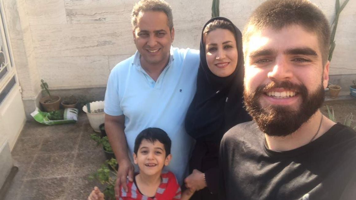 backpacker takes a selfie with his couchsurfing family in the south of Iran