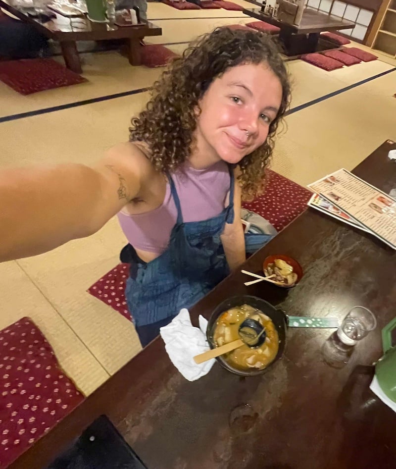 Girl takes selfie eating Hoto Noodles in Japan.