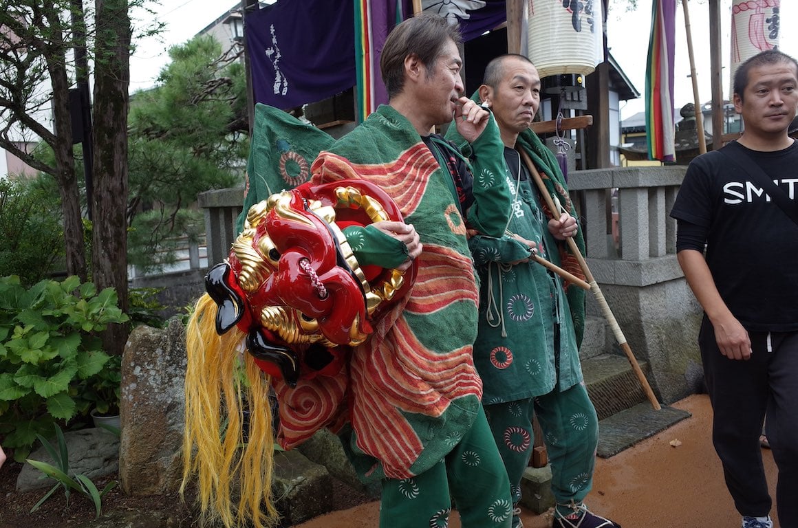 Guys get ready for a traditional dance at a festival in Takayama, Japan.