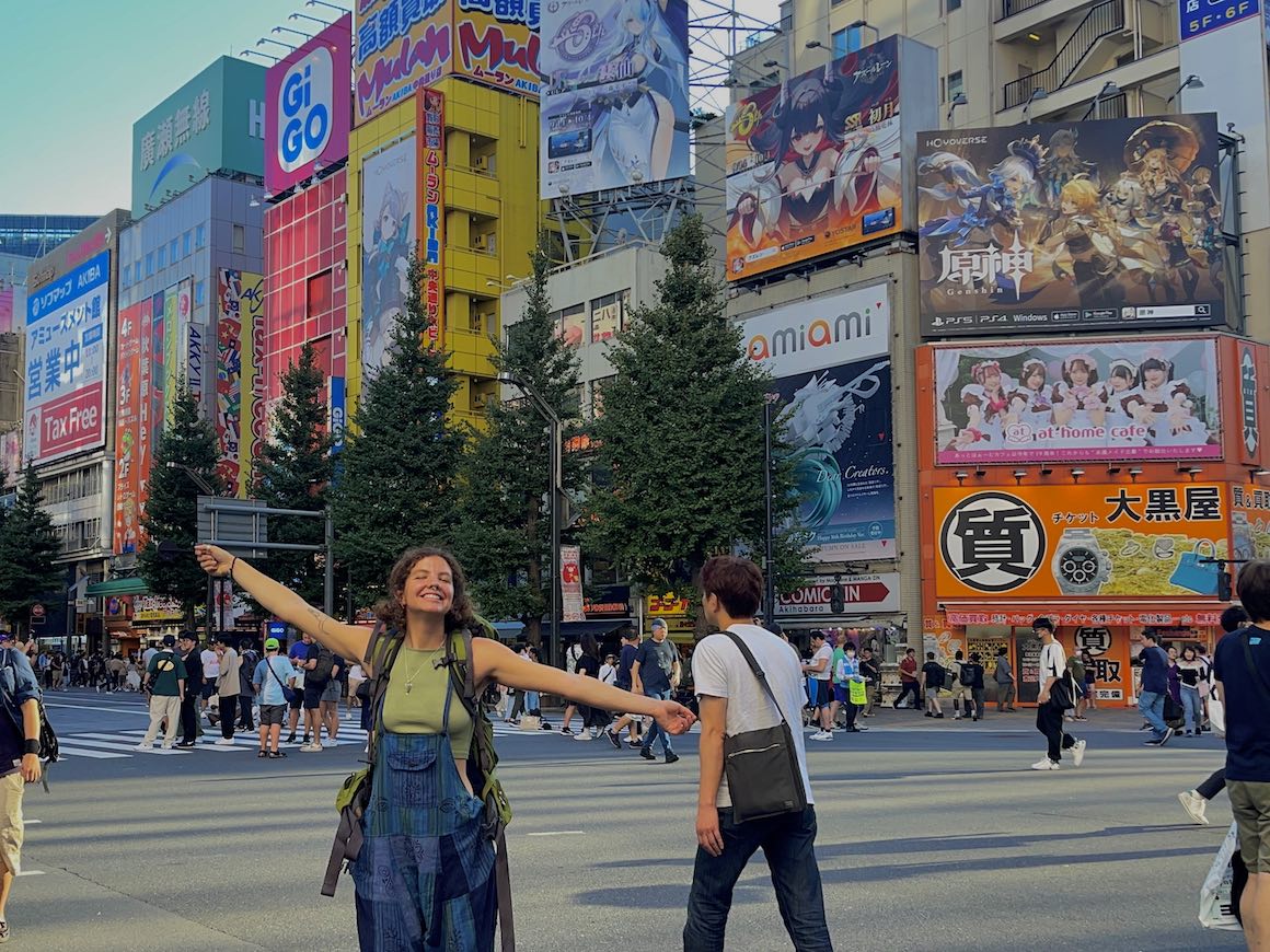 Girl poses for a photo in the busy streets of Tokyo, Japan.
