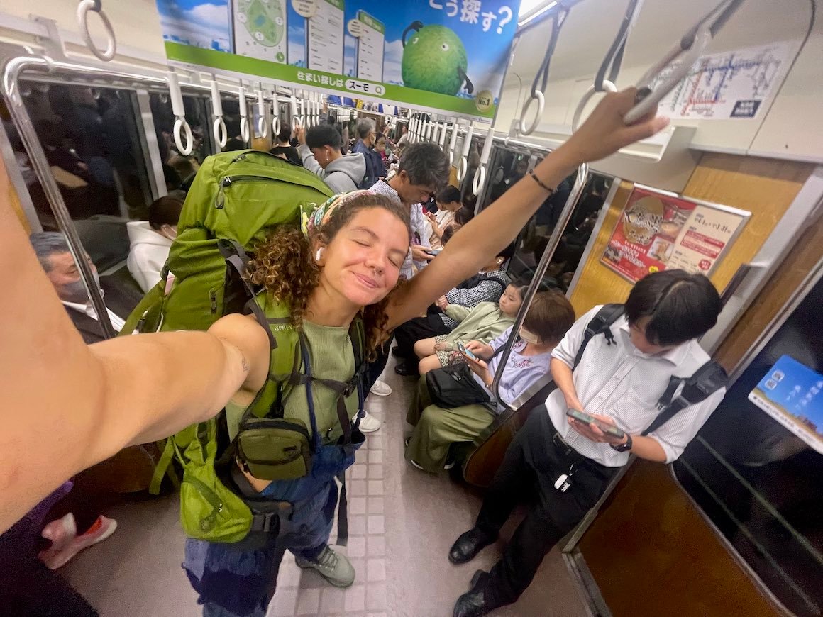 Girl takes selfie while taking public transport in Tokyo, Japan.