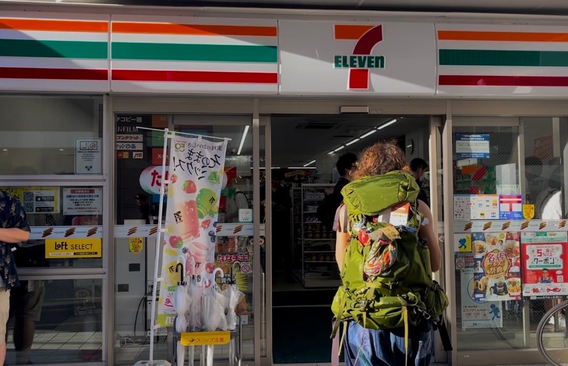 Backpacker walks into a 7/11 in Japan with her backpack on.