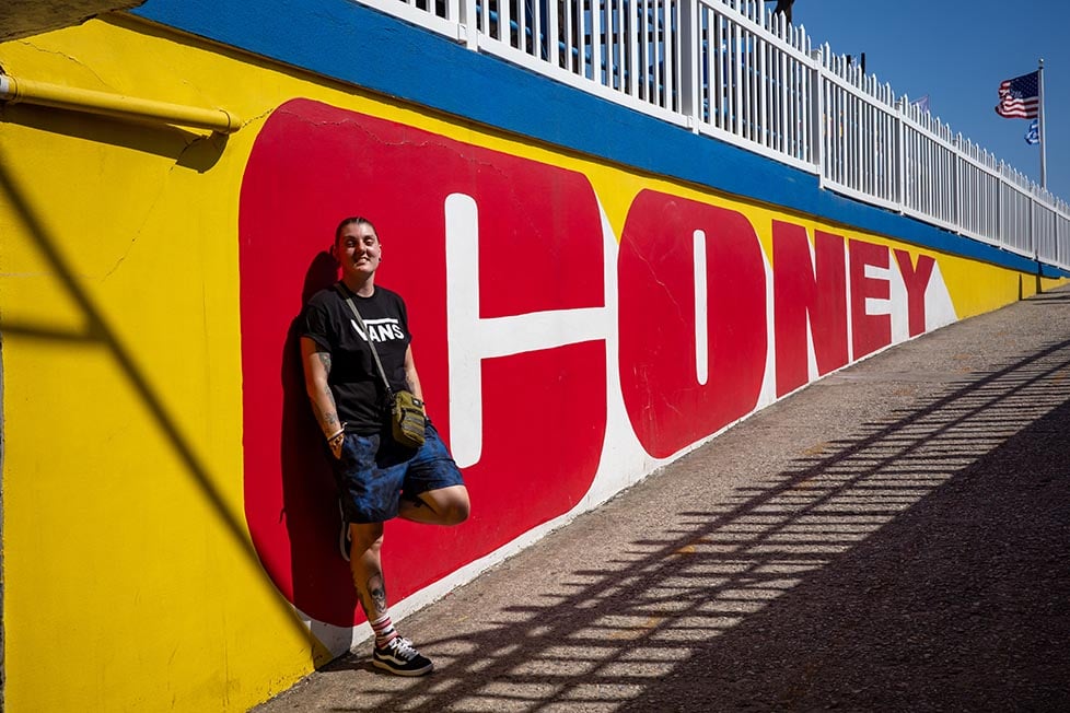 A person stood by the Coney Island sign at Luna Park, Brooklyn, NYC