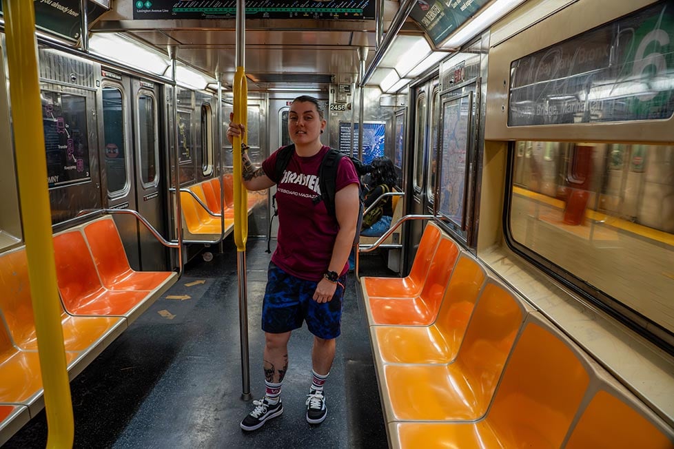 A person stood in an NYC train car