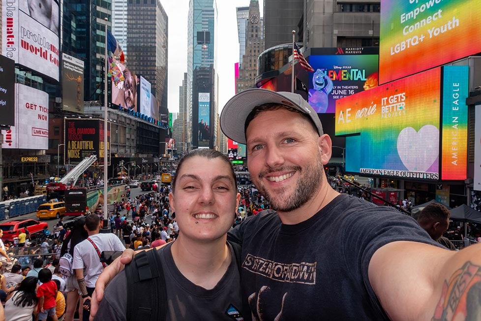 Two people taking a selfie in Times Square NYC