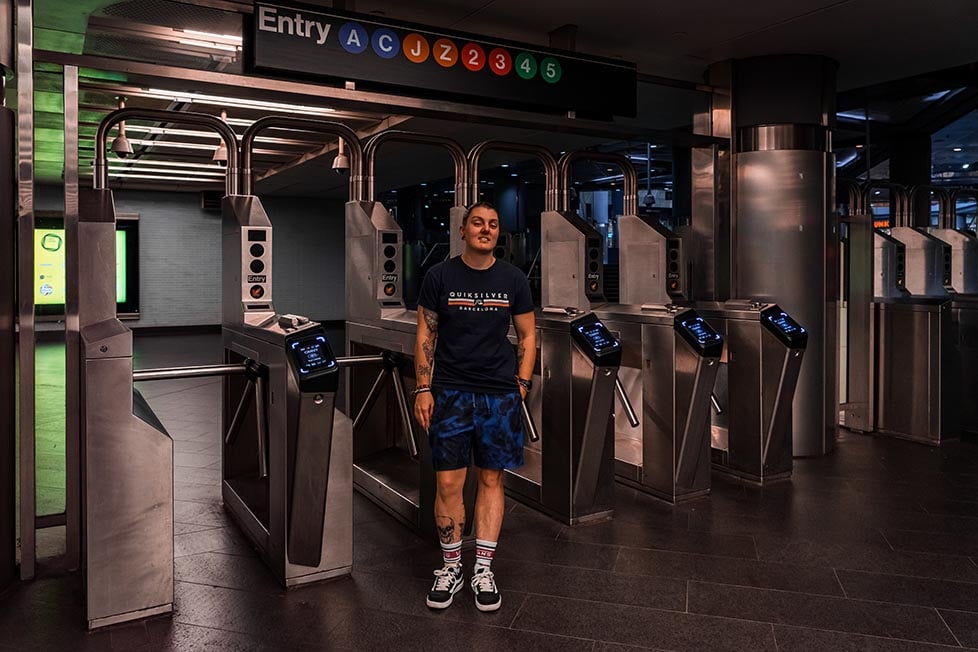 Person stood by the turnstyles in the NYC subway