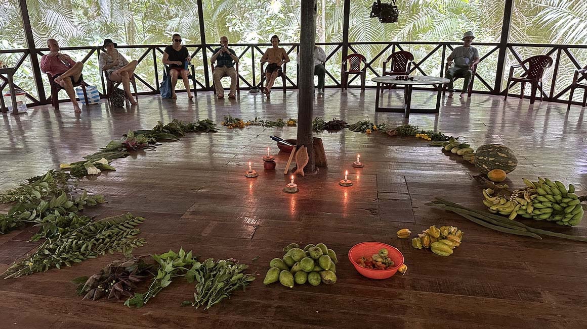 circle of food with candles in the centre and people in a circle at the edge of the structure