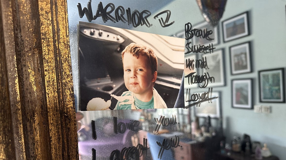 Baby picture on a mirror with positive affirmations written on it.