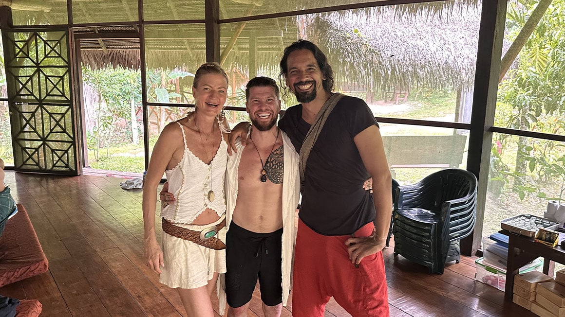Will smiling with the facilitators of the retreat either side of him