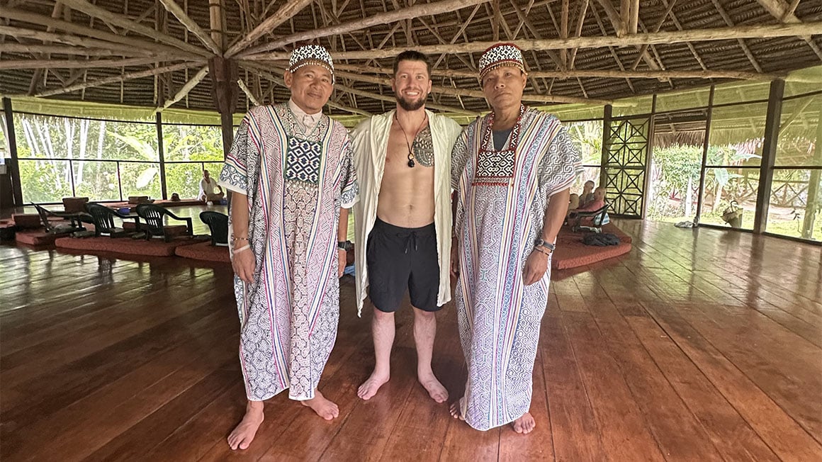 Man with two shamans in ayahuasca retreat.