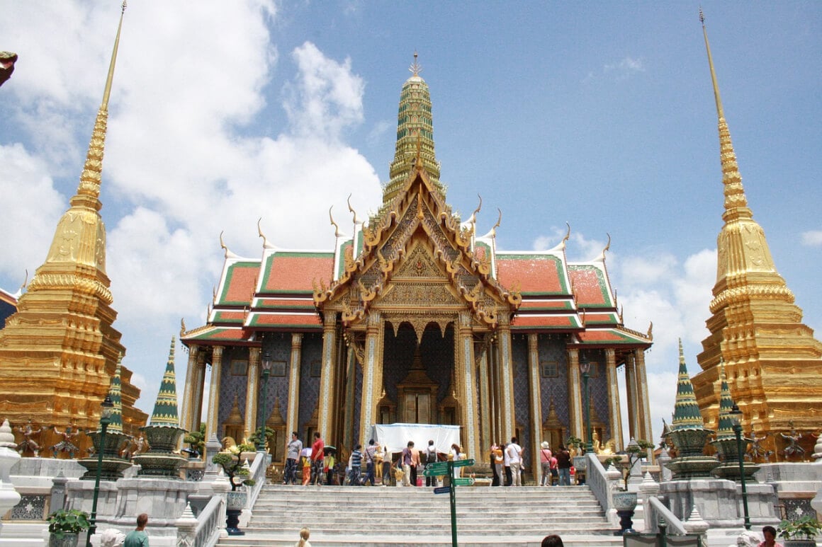 A group of people standing in front of The Grand Palace in Bangkok, Thailand
