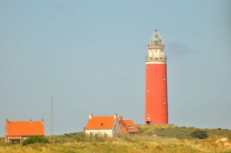 The Eierland lighthouse surrounded by white houses with red roof on the island of Texel in the Netherlands