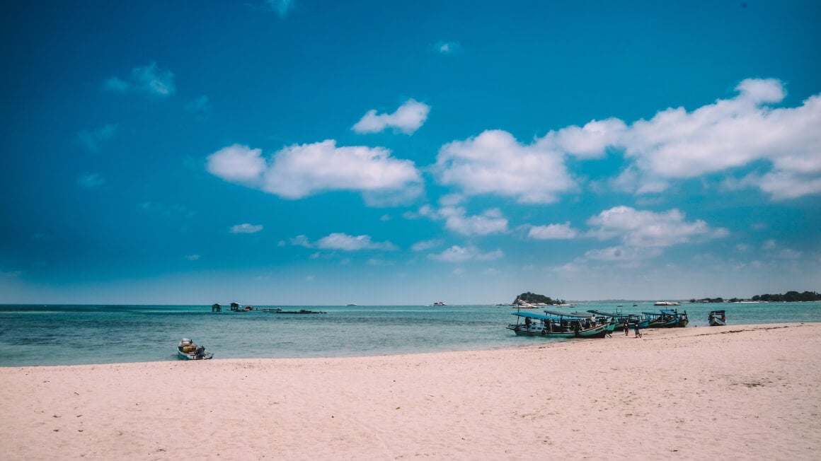 Bangka Belitung Islands' coastline with boats lining at the shore
