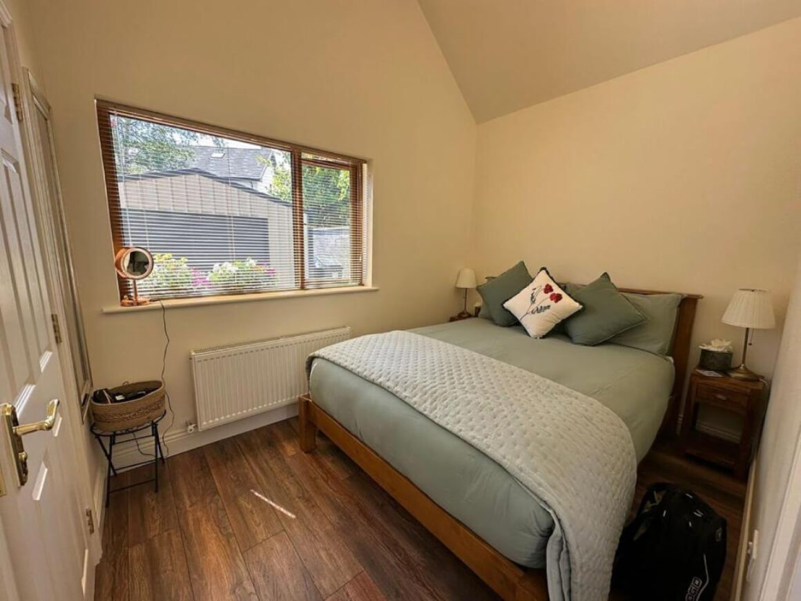 Room in Oranhill Lodge. Wooden floors and big comfy looking bed.