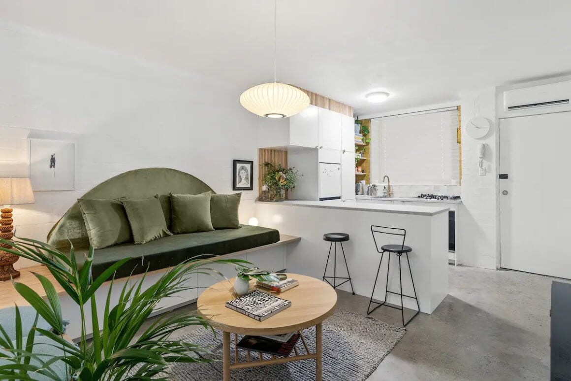 White and green themed kitchen and lounge area. 