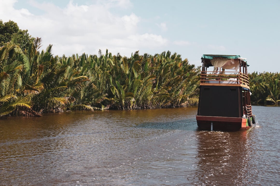 A boat floating down a river in Tanjung Puting National Park, Kalimantan, Borneo