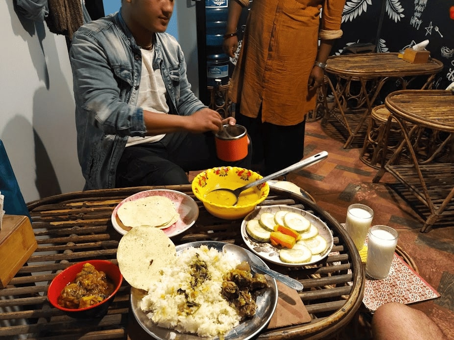 nepali man sharing a meal while trekking in the annapurna region