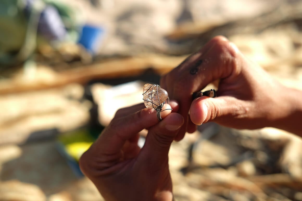 handcrafts on the beach working with silver and precious stones