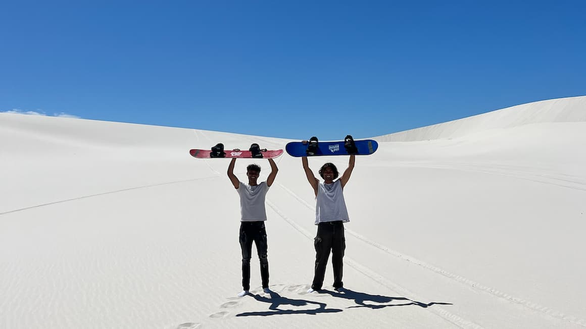 two guys sand boarding in South Africa