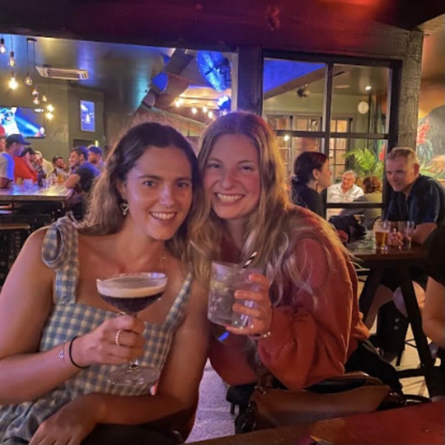 Two friends having a cocktail in a bar