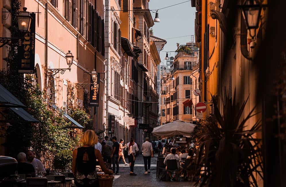 Looking down a street half in sunlight in Rome, Italy