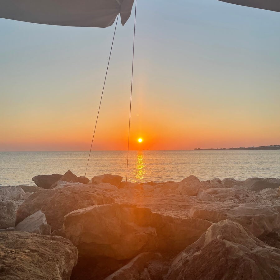 Beautiful sunset over the ocean with a rocky foreground