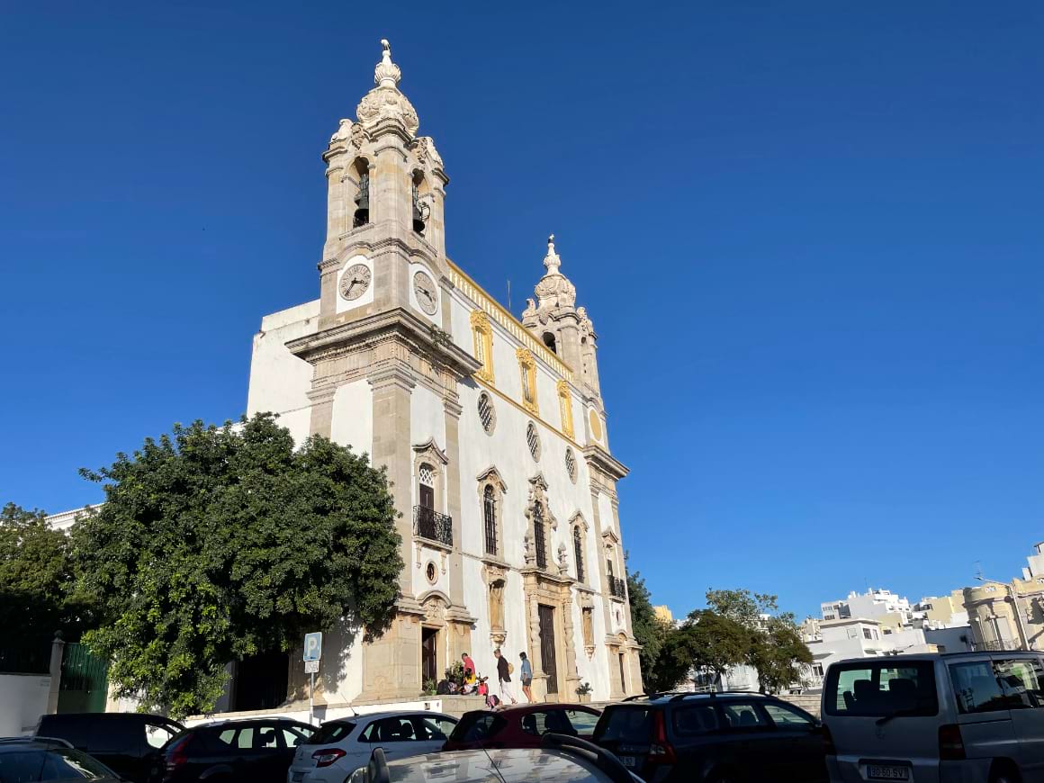 White building with a clock tower in Faro, Portugal