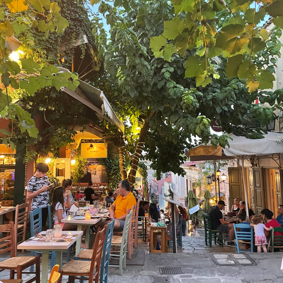 Streets of Plaka filled with restaurants, people and trees