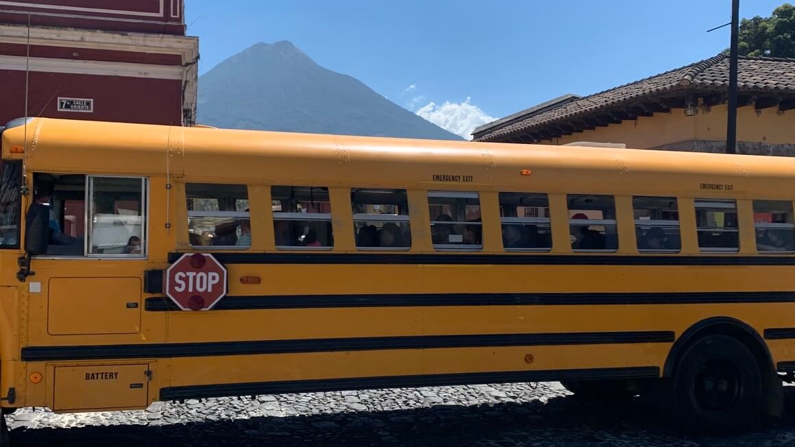 Bus and volcano in Antigua Guatemala