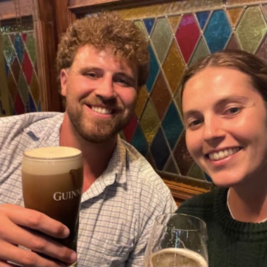 Two friends at a pub having a Guiness and a wine