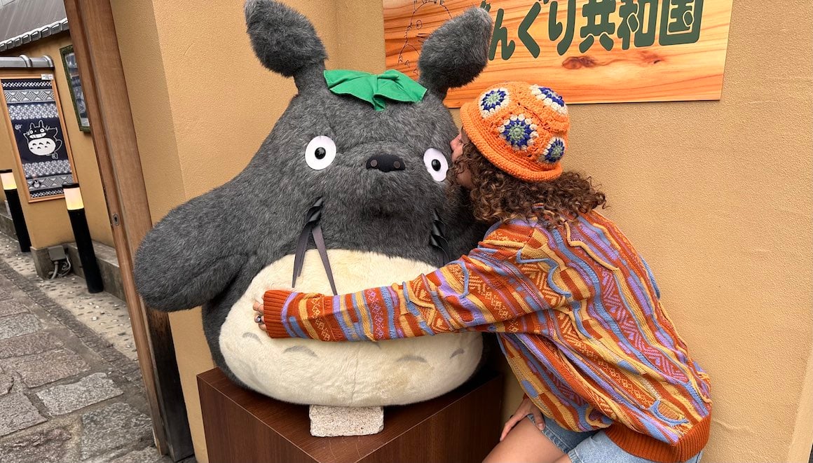 Girl kissing giant Totoro at Studio Ghibli Museum in Japan.