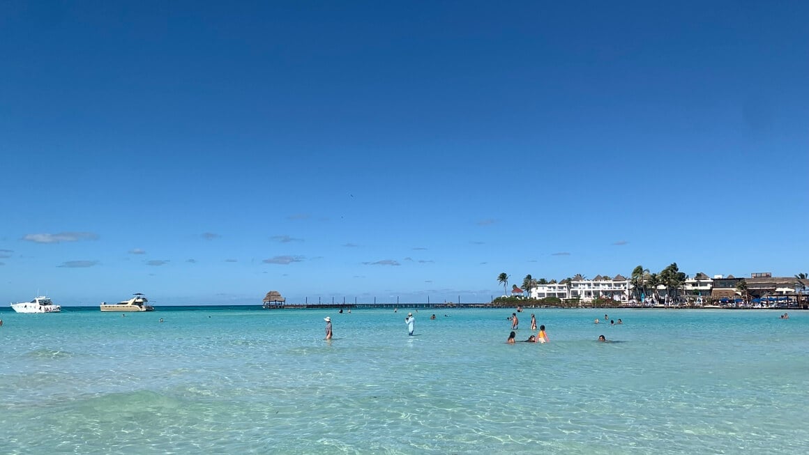 Blue skies, Crystal clear water. People playing the sea. Playa Norte Isla Mujeres