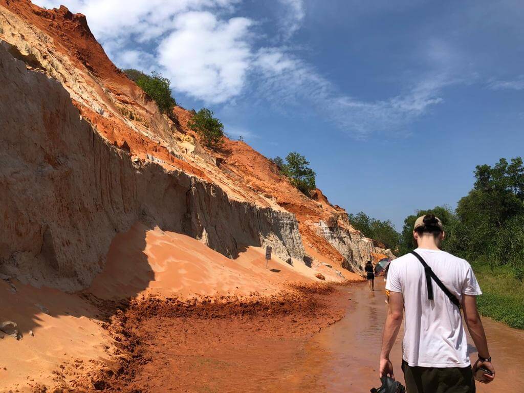 Man strolling by Mui Ne sand dunes in Vietnam