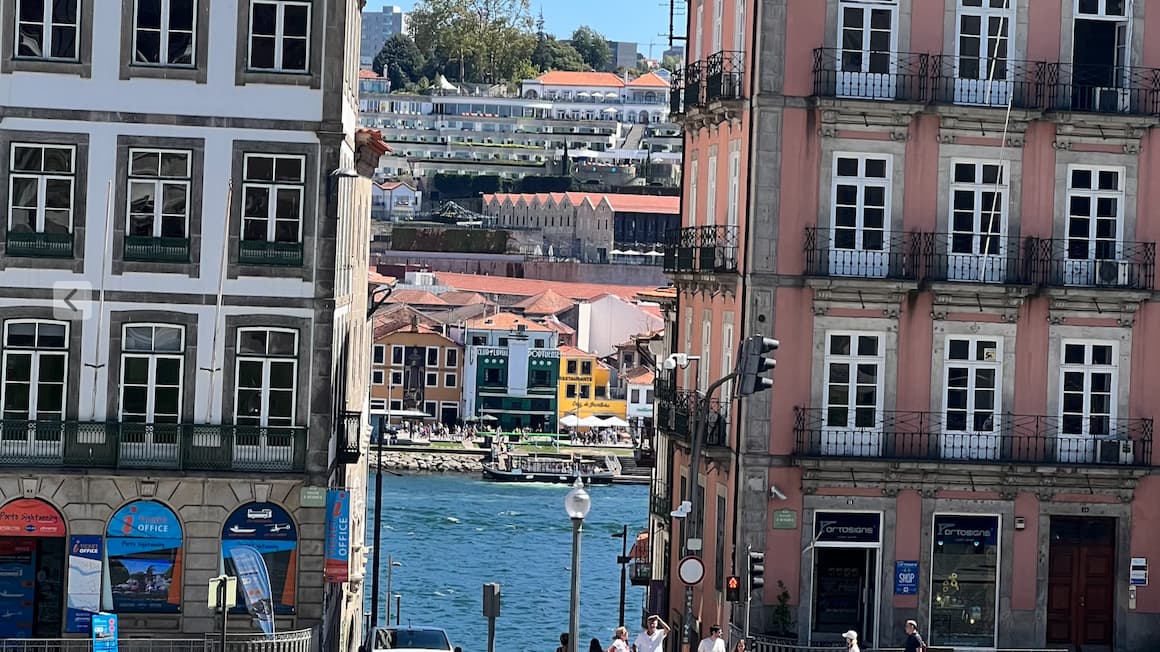 a view of Portuguese victorian style buildings with the bay in the background  