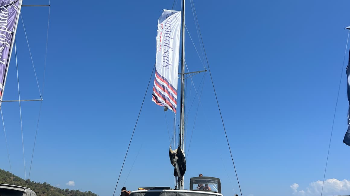 a sail boat in the sea with a blue sky in the background 