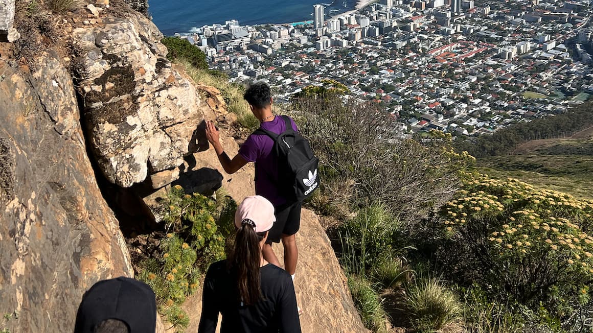 a family hiking in Cape Town with a view of the ocean