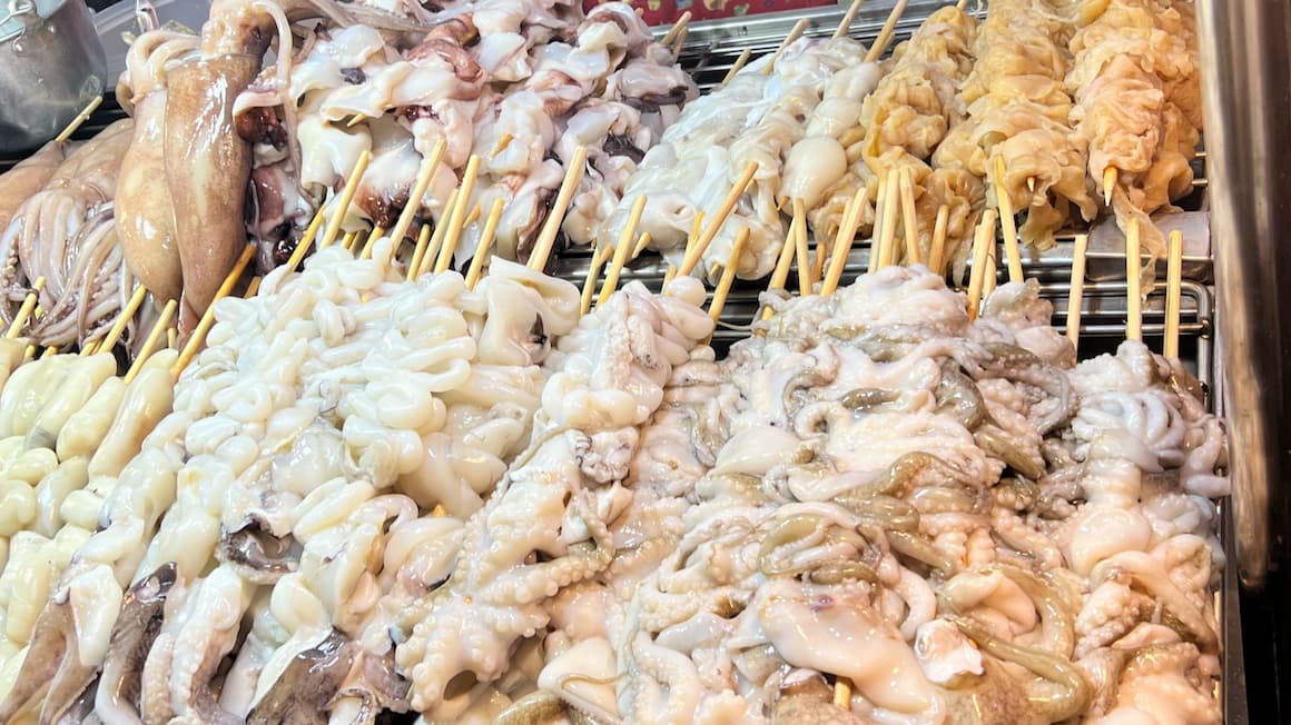 raw squid and fish, street food in bangkok thailand 