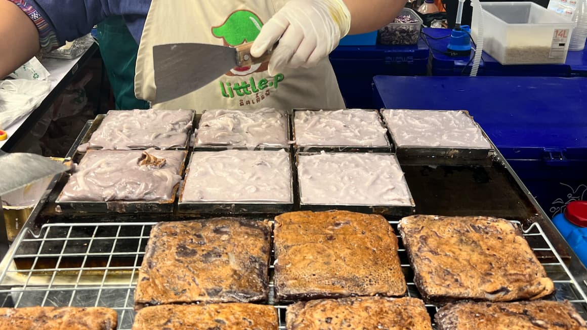 Thai coconut pancakes being prepared