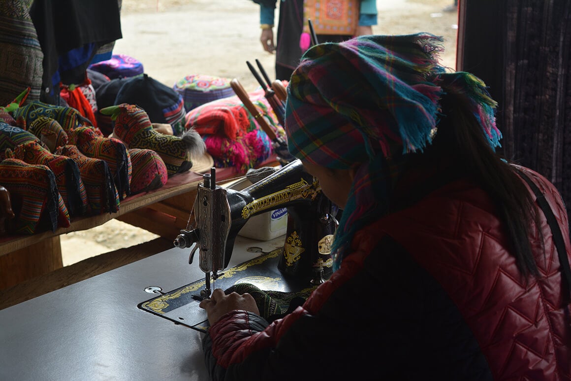 a woman works with a sewing machine in Sapa, northern Vietnam