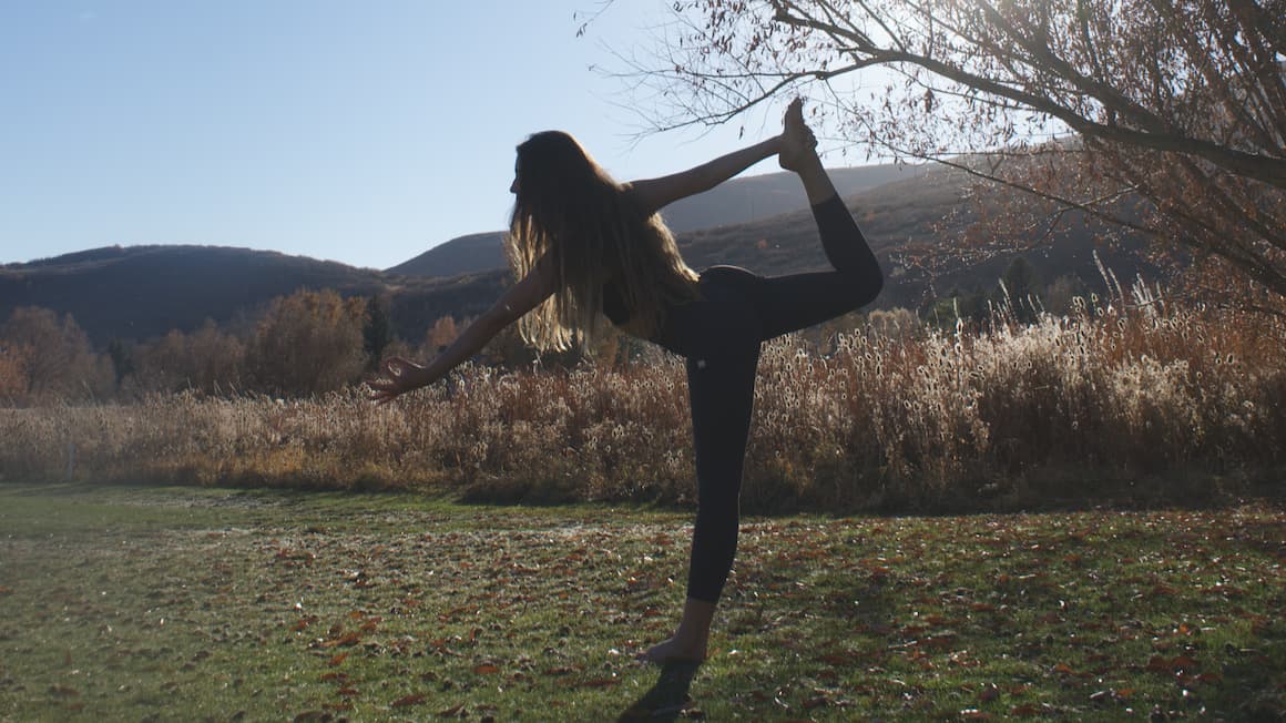 a girl doing yoga in the mountains of utah 