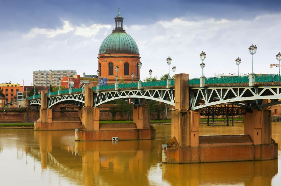 Saint Pierre bridge crossing Garonne River with Chapel Saint Joseph de la Grave in the background