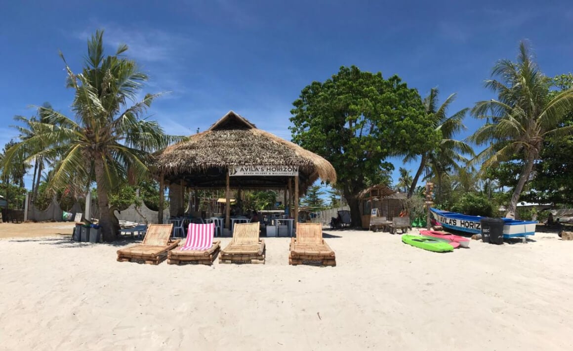 Avila’s Horizon Dive Resort with beach chairs and a hut on a Langub beach 