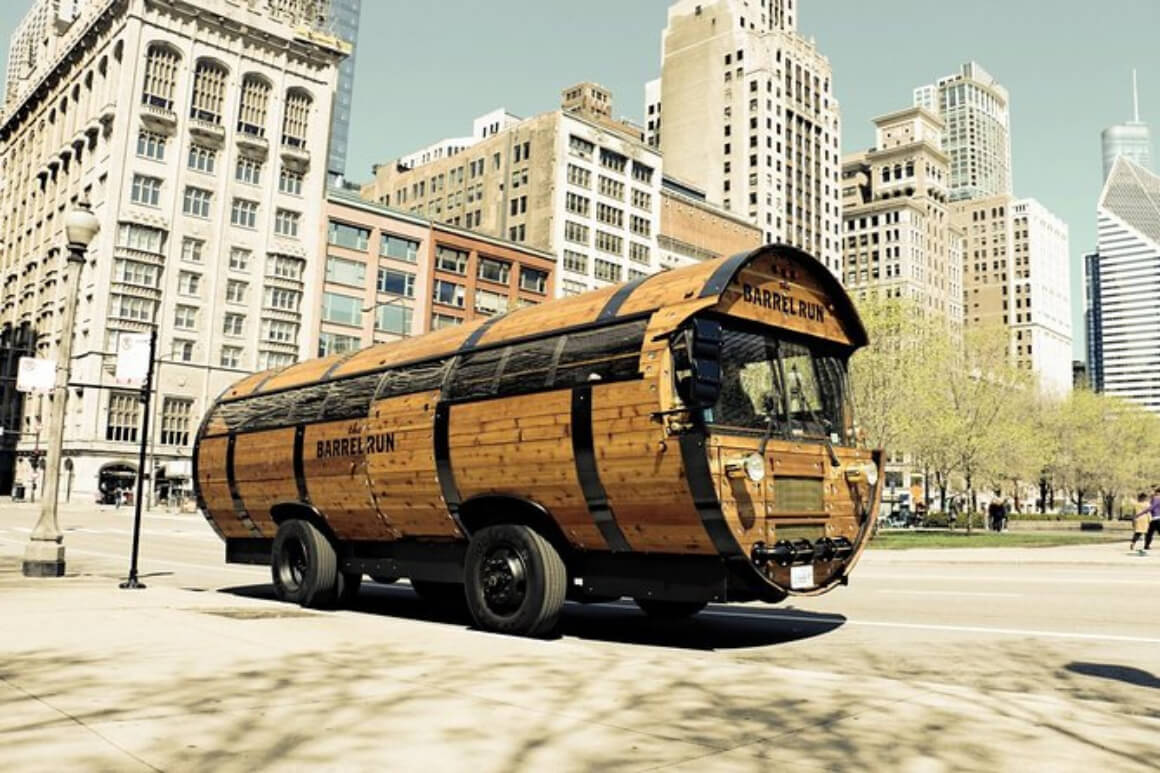 bus shaped like a giant wooden barrel with Chicago buildings in the backdrop 