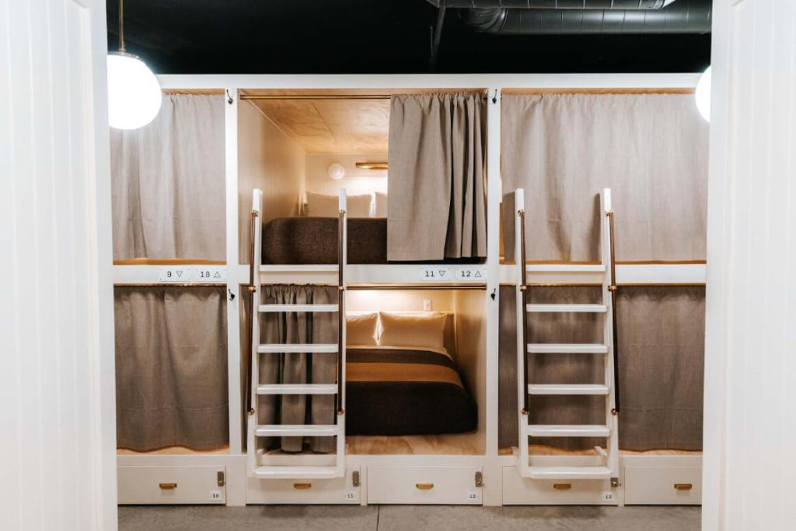 Cache House dorm room beds with ladder and curtains